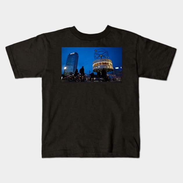 Berlin Alexanderplatz night Scene, with the Weltzeituhr (World Time Clock), built in 1969, and the Park Inn Hotel highrise in the background Kids T-Shirt by Reinvention